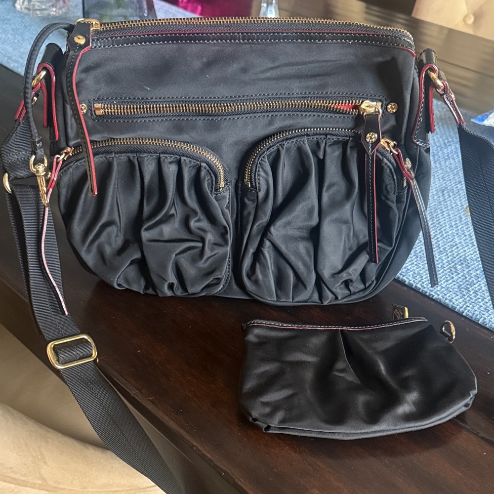 MZ Wallace Black Crossbody Bag with Red Accents.